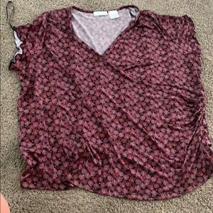We have a low v-neck blouse in the color magenta